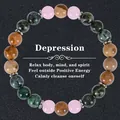Detail of healing beaded bracelet featuring rose quartz and green stone with silver spacers - Pink Brown Green Black Textured Beads (Depression-7)