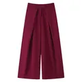 Detail view of the elegant pleated burgundy wide-leg trousers with flat waistband - Burgundy