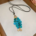 Fish pendant necklace with golden metal and layered blue shell detail and cord - Light Blue Shell Scale Fish Shaped Pendant Necklace