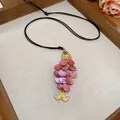 Pink shell fish pendant necklace with evil eye detail and black woven cord strap - Pink Shell Scale Fish Shaped Pendant Necklace