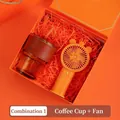 Orange business gift set featuring a glass coffee cup with leather sleeve and mini fan - Amber Glass Cup Orange Fan (PA-01)