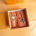 Orange business gift set featuring a portable crown fan, notebook, and key-shaped pen - Orange Fan Notebook Key Pen (PA-18)