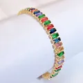 Detailed close-up of rainbow zircon bracelet with gold-plated metal prong setting - Bracelet / Gold
