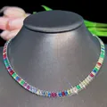 Detailed macro view of vibrant rainbow tennis necklace with rectangular-cut gemstones - Necklace / Silver