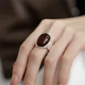 Vintage S925 sterling silver open ring featuring a large oval dark red gemstone on a finger - Oval Deep Red Gem Vintage Open Style (JZ0948)