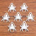 Set of seven white metal spider charms for DIY jewelry making on wood background - Style 7 White 13x18mm