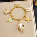 Gold-plated stainless steel ocean charm bracelet featuring shell and starfish pendants - Ray Shell Ocean Style (B2165)