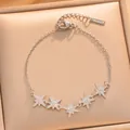 Detailed view of silver eight-pointed star charms with micro-pave zircon on bracelet. - Silver Star Bracelet