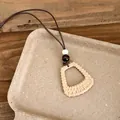 Detail view of Bohemian woven geometric pendant necklace with wooden bead accents. - Rectangular Style (HN12219) / 1 Piece / Brown