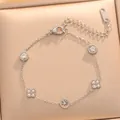 Close-up of a gold-plated titanium steel bracelet featuring zircon flower and circle charms - 734 Silver Bracelet / Silver