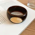 Close-up view of dark brown tortoiseshell acrylic bangle with cream marbled oval stone - Brown-Beige