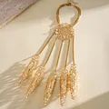 Detailed macro view of a gold hollow finger sleeve bracelet featuring filigree design - Mandala Hollow Style / Gold