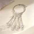 Detailed view of a silver hollow butterfly slave bracelet with intricate filigree rings - Hollow Butterfly Style / Silver