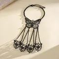 Detailed shot of a black hollow butterfly slave bracelet with four finger rings - Hollow Butterfly Style / Gunmetal