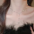 Elegant French style pearl necklace with a sparkling crystal heart pendant worn on neck - Style 10