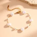 Elegant detail view of a gold chain bracelet with white shell beads and small pearls - White Shell Bracelet (K707)