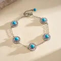 Detail view of retro silver bracelet with round textured blue resin charms. - Bracelet / Silver-Blue