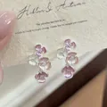 Close-up detail of sweet enamel floral stud earrings featuring tiny diamond center stones - Silver (Silver Pin) / Pink
