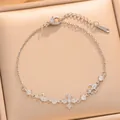 Detail view of dainty silver plated bracelet with sparkling zirconia flower charm. - Cross Fleur-de-lis Style (S1127) / Silver