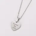 Close-up macro detail of stainless steel heart pendant with Forever My Love engraving - Forever My Love Engraved / Steel
