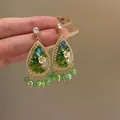 Exquisite close-up of vintage green teardrop earrings with delicate flowers and tassels - Teardrop Tassel Style (HE33832) / Gold-Green
