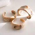 Set of three minimalist irregular acrylic cuff bracelets featuring beige marble swirl pattern - Three-Piece Set / Khaki