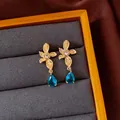 Elegant vintage gold floral earrings with blue teardrop crystal pendants in box - Style 24