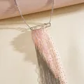 Close-up of pink glass bead and silver chain tassel necklace with safety pin - Pink