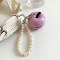 Close-up of a stylish pearl heart keychain featuring a purple apple charm on a canvas bag - Pearl Heart Purple Apple Pendant