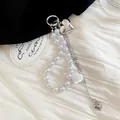 Close-up of pearl beaded keychain featuring silver and pearlescent heart charms. - Pearl Silver Heart Multi-layer Chain