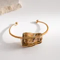 Detailed view of vintage natural crystal rough stone and gold wire wrapping on bracelet - Amber (Tiger Eye) / Gold