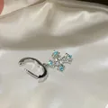 Silver cross dangle earring with blue and white cubic zirconia on white satin - Silver Cross Pendant Style (HE33707-1) / Silver Needle / Blue