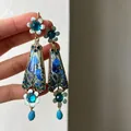 Detailed view of vintage-style blue floral crystal pendant earrings with iris art - Vintage Palace Iris Style (HE33766-) / Silver Earring Post - Gold - Blue