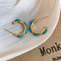 Primo piano di orecchini vintage dorati con pietre turchesi e dettagli in cristallo - 24# Perno Argento Oro Blu