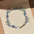 Close-up of light blue crystal flower bracelet with pear-shaped stones and silver finish - Blue