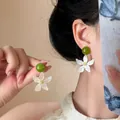 Elegant white gardenia flower drop earrings with green beads shown on an Asian model. - Five-Petal Star Gardenia Style (HE33765-1) / White-Green