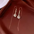 Detailed view of 14k gold plated teardrop ear threader earrings with sparkling crystals. - Pipa Lute Ear Thread / Gold