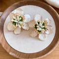 Close-up view of vintage enamel flower stud earrings featuring intricate stamen details - Vintage Floral Style (HE33634) / White