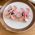 Detailed close-up showing the glossy pink enamel and gold petals of these flower earrings. - Vintage Floral Style (HE33634) / Pink