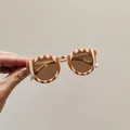 Stylish children's round sunglasses featuring orange and white striped frames and brown lenses - Round / Beige Stripes