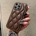 Macro shot of brown quilted puffy leather case with wave stitching for iPhone - 17 Pro / Coffee