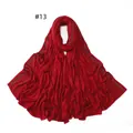 Detail of red jersey scarf featuring shimmering gold bead embellishments on soft fabric - 13