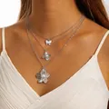 Elegant triple layered silver necklace with flower and pearl pendants on a model. - Silver Butterfly Pearl 3-Layer Layered Necklace (29945-nek-S)