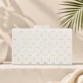 Elegant white lace acrylic evening clutch bag with marble clasp in sunlit studio - Lace