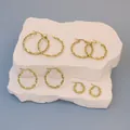 Golden twisted stainless steel hoop earrings in four sizes on textured stones - 30MM / Gold