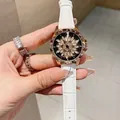 Rose gold fashion watch with floral crystal dial and white leather strap on wrist - Rose Gold White Leather Strap