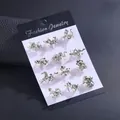 12-piece silver zodiac stud earrings set with white pearls on a black display card - Silver Tone Twelve Zodiac Artificial Pearl Style (KZ066-2)