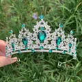 Detailed shot of vintage silver bridal tiara with green emerald stones on grass - Silver + Green Zirconia