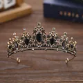 Elegant vintage black and gold wedding tiara with crystals on a wooden surface - Antique Gold + Black
