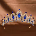 Golden bridal crown featuring deep blue teardrop gems and white crystal accents - Gold + Royal Blue